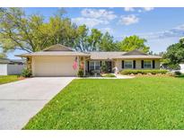 Charming single-story home with a well-manicured lawn, stone accents and attached two car garage at 3952 Applegate Cir, Brandon, FL 33511
