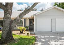 Charming single-story home featuring a one-car garage, well-kept lawn, and delightful curb appeal at 39650 Us Highway 19 N # 615, Tarpon Springs, FL 34689