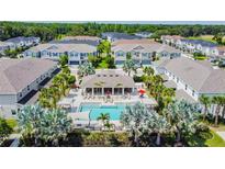 A beautiful community pool is surrounded by tropical landscaping and residences at 1018 Rose Blossom Ct, Tampa, FL 33613