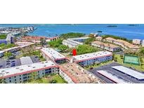 Gorgeous aerial view of the community and waterfront, showcasing tennis courts and convenient parking at 2700 Bayshore Blvd # 4204, Dunedin, FL 34698