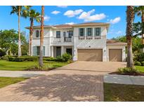 Stunning two-story home featuring a brick driveway, lush landscaping, and an attached two-car garage at 3226 Cordoba Ranch Blvd, Lutz, FL 33559