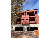 Exterior view of new construction home with a drive-under two-car garage and light colored walls at 4509 W North A St # 1, Tampa, FL 33609