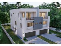 Contemporary three-story home with a modern design, dual balconies, and a two-car garage, set amongst mature trees at 4509 W North A St # 1, Tampa, FL 33609