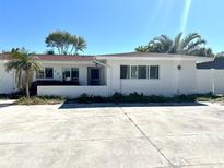 Charming one-story home with a white brick facade and well-lit front at 121 175Th E Ave, Redington Shores, FL 33708