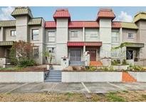 Exterior front view of townhomes with manicured landscaping and front patios at 170 E Davis Blvd, Tampa, FL 33606