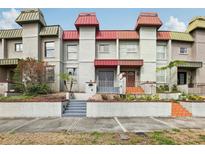 Inviting townhouse featuring a unique facade with red roof accents and well-maintained landscaping at 170 E Davis Blvd, Tampa, FL 33606