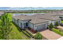 Beautiful single-story home with a brick driveway and a serene water view, located in a desirable community at 19212 Iron Topsail Isle, Land O Lakes, FL 34638