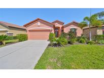Charming single-story home features a manicured lawn and vibrant landscaping enhancing its curb appeal at 349 Laurel Falls Dr, Apollo Beach, FL 33572