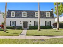Charming two-story home with a well-manicured lawn and classic architectural details at 4506 W Beachway Dr, Tampa, FL 33609