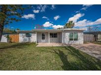 Charming single-story home featuring a well-maintained lawn and a cozy front porch area at 5411 96Th N Ter, Pinellas Park, FL 33782