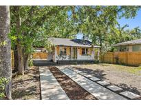Charming single story home featuring a covered driveway, minimalist front yard landscaping, and a quaint front porch at 828 20Th S Ave, St Petersburg, FL 33705