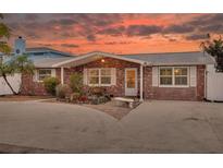 Charming brick home featuring a well-manicured front yard, offering warmth and curb appeal at 12821 5Th Isle, Hudson, FL 34667