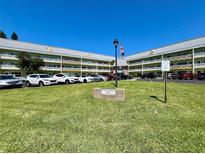 Exterior view of the Southern Georgian condos, showing the complex and parking on a sunny day at 2460 Canadian Way # 36, Clearwater, FL 33763