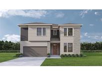 Charming two-story home featuring a well-manicured lawn, a two-car garage, and a welcoming front door at 3319 W Marlin Ave, Tampa, FL 33611