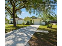 Inviting single-story home with well-manicured lawn and a long driveway leading to an attached garage at 4036 56Th N Ave, St Petersburg, FL 33714