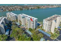 Aerial view of waterfront condos with covered parking and lush landscaping near the waterway at 7932 Sailboat Key S Blvd # 806, South Pasadena, FL 33707