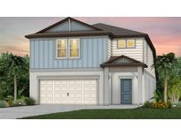 Charming two-story home with light blue siding, a two-car garage, and well-manicured landscaping at 9767 Crescent Moon Dr, Riverview, FL 33578