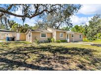 Charming single-story home with a well-maintained lawn and mature trees at 1796 Harbor Dr, Clearwater, FL 33755