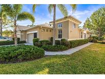 Charming single-Gathering home featuring stucco exterior and well-manicured landscaping with palm trees at 1922 Sifield Greens Way # 47, Sun City Center, FL 33573