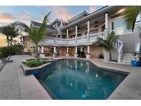 Beautiful pool with lush landscaping, a lounge area, and a spacious backyard at 6113 Pasadena Point Blvd, Gulfport, FL 33707