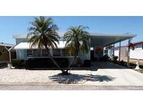 Charming single-story home with a carport, palm trees, and well-kept landscaping in a quiet neighborhood at 665 54Th S St # 133, Gulfport, FL 33707
