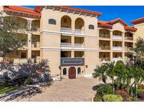Stunning condo building with manicured landscaping and a paver drive, exudes curb appeal at 7710 Lake Vista Ct # 205, Lakewood Ranch, FL 34202