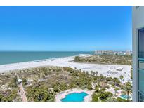 Breathtaking aerial view of the beach, ocean, and community pool, a luxurious coastal living experience at 1180 Gulf Blvd # 1201, Clearwater, FL 33767