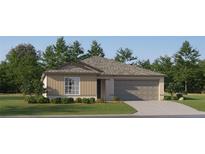Charming single-story home with a two-car garage, front lawn and beautiful landscaping at 12964 Shining Blue Nile Ln, Parrish, FL 34219