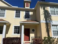 Charming townhome featuring cream-colored exterior, well-maintained landscaping, and inviting front entrance at 2061 Fiesta Ridge Ct, Tampa, FL 33604