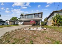 Charming two-story home featuring a well-maintained lawn and an attached garage at 6680 67Th N Way, Pinellas Park, FL 33781