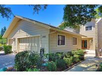 Charming home with a two-car garage, landscaped yard, and beautiful curb appeal on a sunny day at 1093 Muirfield Ct, Tarpon Springs, FL 34688