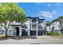 Stylish condo building boasts a modern design, three stories, and convenient garage parking at 13016 Sanctuary Cove Dr # 201, Temple Terrace, FL 33637