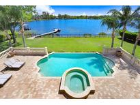 Resort style pool and spa overlooking the lake at 17111 Journeys End Dr, Odessa, FL 33556