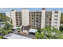 Multi-story condo complex featuring covered parking and beautifully landscaped surroundings at 2700 Cove Cay Dr # 5-G, Clearwater, FL 33760