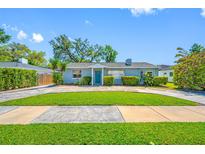 Charming single-story home with a well-manicured lawn, lovely landscaping, and a cozy feel at 3310 W Swann Ave, Tampa, FL 33609