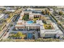 An aerial view of the condo complex with swimming pool, tennis courts, and ample parking at 5820 N Church Ave # 148, Tampa, FL 33614