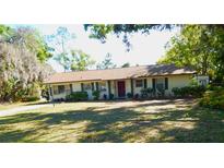 Charming single-story home with well-manicured lawn and mature trees in a peaceful residential setting at 908 N Knight St, Plant City, FL 33563