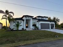 Beautiful new construction home with lush landscaping and a three car garage at 9514 Snapper Cir, Port Charlotte, FL 33981