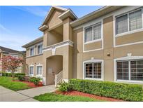 Inviting condo with landscaped grounds, featuring covered entry and a well-maintained facade at 9526 Newdale Way # 101, Riverview, FL 33578
