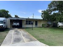 Charming single-story home with a well-maintained lawn and covered parking in a suburban neighborhood at 1606 Marilyn Ave, Bradenton, FL 34207