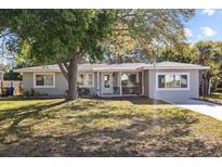 Charming single-story home with a well-maintained front yard and mature trees offering shade at 1653 S Prescott Ave, Clearwater, FL 33756