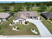 Well-maintained single-Gathering home with lush landscaping, circular driveway, and charming curb appeal at 2007 E View Dr, Sun City Center, FL 33573
