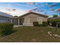 Charming single-story home featuring a covered carport and freshly landscaped front yard at 2125 W Cypress St, Tampa, FL 33606