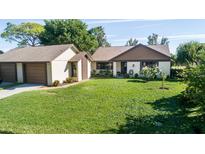 Charming single-story home with a well-manicured lawn and attached two-car garage, exuding curb appeal at 2254 Sequoia Dr, Clearwater, FL 33763