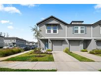 Charming two-story townhome with gray siding and a well-manicured front lawn at 2760 Scarlet Bay Pl, Brandon, FL 33510