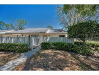 Landscaped front yard with pathway leading to inviting home entrance at 1333 Shady Pine Way # F, Tarpon Springs, FL 34688