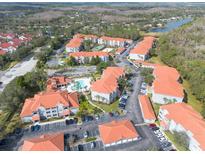 A captivating aerial view of a condo community boasting a pool, tennis courts, and lush landscaping at 18001 Richmond Place Dr # 1032, Tampa, FL 33647