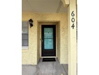 Inviting front door entrance with black-trimmed glass door, textured walls, and visible unit number at 2465 Northside Dr # 604, Clearwater, FL 33761