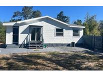 A charming single-story home featuring a textured exterior and a well-maintained yard at 300 S Highland Ave, Tarpon Springs, FL 34689