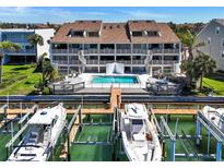 Waterfront condo with boat slips and a sparkling pool in a picturesque coastal setting at 350 Pinellas Bayway S # 2, St Petersburg, FL 33715
